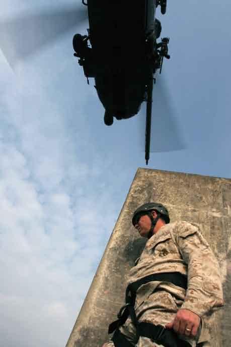course instructor, stands by on a rooftop in Central Training Area s combat town