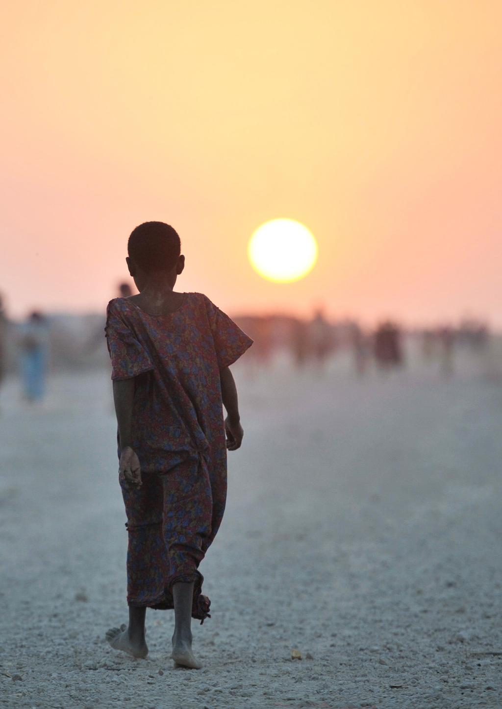 INTRODUCTION OCHA A Somali girl walks down a road at sunset in an IDP