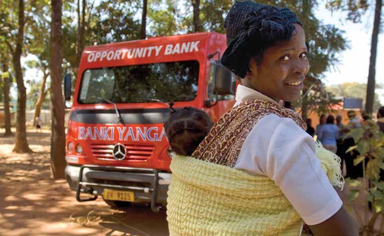 Photo: Bill & Melinda Gates Foundation A mother and child stand near a mobile banking vehicle in Michinji village, approximately 120km west of the capital Lilongwe, Malawi.