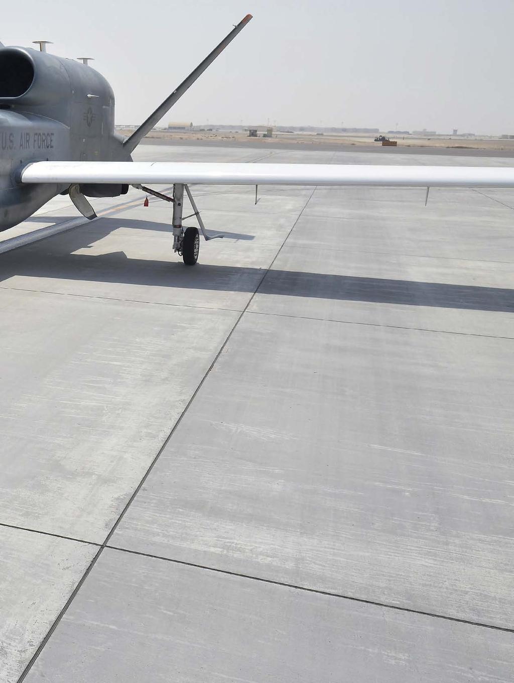 A crew chief escorts an RQ-4 back to a hangar in Southwest Asia. Because of sequestration, USAF tried to mothball the Global Hawk in 2013.