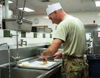 A culinary specialist assigned to the 7th Special Forces Group (Airborne) dices potatoes. (PHOTO BY CAPT. THOMAS CIESLAK, U.S. ARMY SPECIAL OPERATIONS COMMAND.) ing programs of the services.