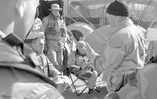 US Army A Marine intelligence officer discusses operations with soldiers and Marines near Kandahar, Afghanistan.