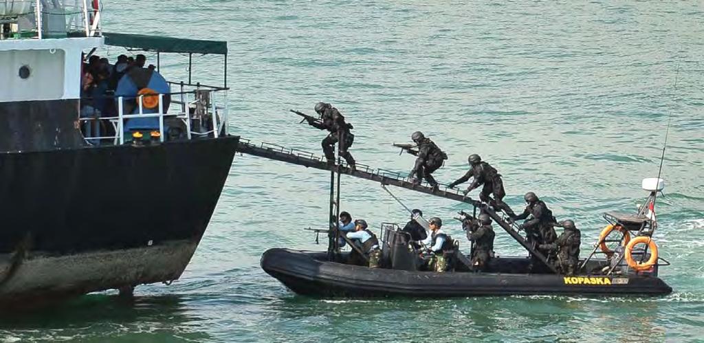 Credit: Singapore Press/AP In a demonstration to senior officers from the Indonesian and Singapore military and law enforcement agencies, Indonesian Navy Kopaska troops storm the hijacked vessel MT
