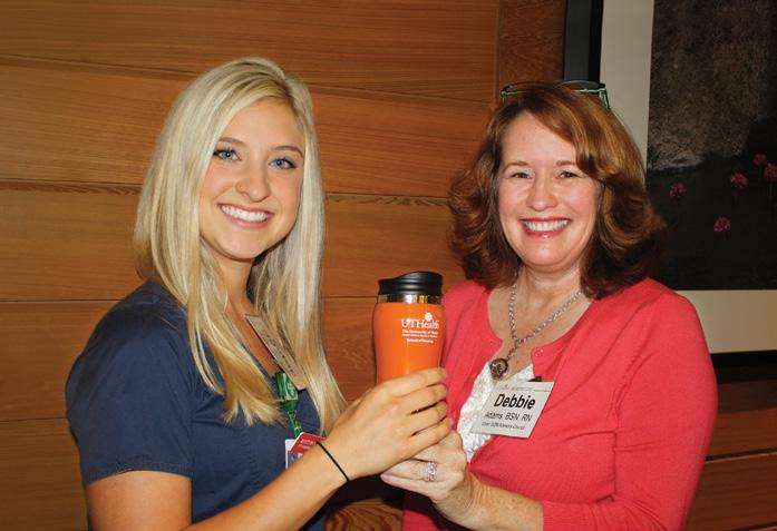 Left, BSN student Boston Yoder accepted the thank-you gift of an insulated UTHealth SON mug from chair Deborah Adams after Boston shared the story with the SON Advisory Council of how a PARTNERS