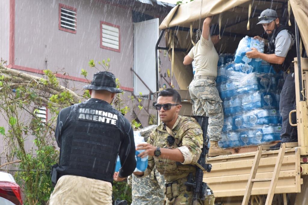 Members of the Coast Guard, FEMA, U.S. Army and Puerto Rico Hacienda deliver water and meals to local residents of Utuado, Puerto Rico, as part of ongoing Hurricane Maria relief efforts Oct. 12, 2017.