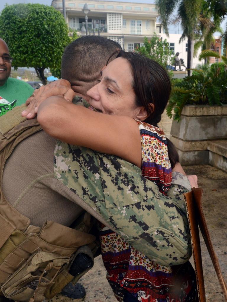 A resident of Moca, Puerto Rico hugs a Coast Guard member after he delivered food and water to the people of Moca, Oct. 9, 2017.