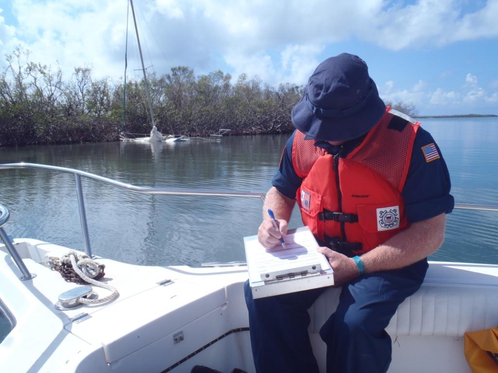 U.S. Coast Guard Petty Officer Heath Ard conducts a vessel assessment to ensure safe removal of damaged, displaced, submerged or sunken vessels as part of the Hurricane Maria ESF 10 PR Unified