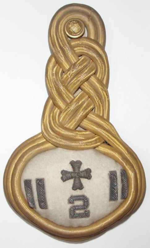and an embroidered medical insignia on a white background.