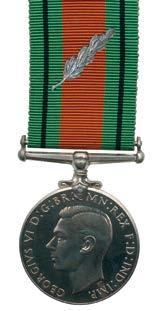 The civilian badge for the King s Commendation for Brave Conduct was initially a gold colour plastic badge (40 mm high by 21 mm wide) displaying an upright sword in a wreath of laurel leaves topped
