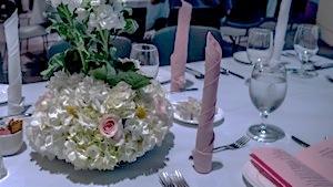 The food was served on fine china and striking flower arrangements adorned the tables.