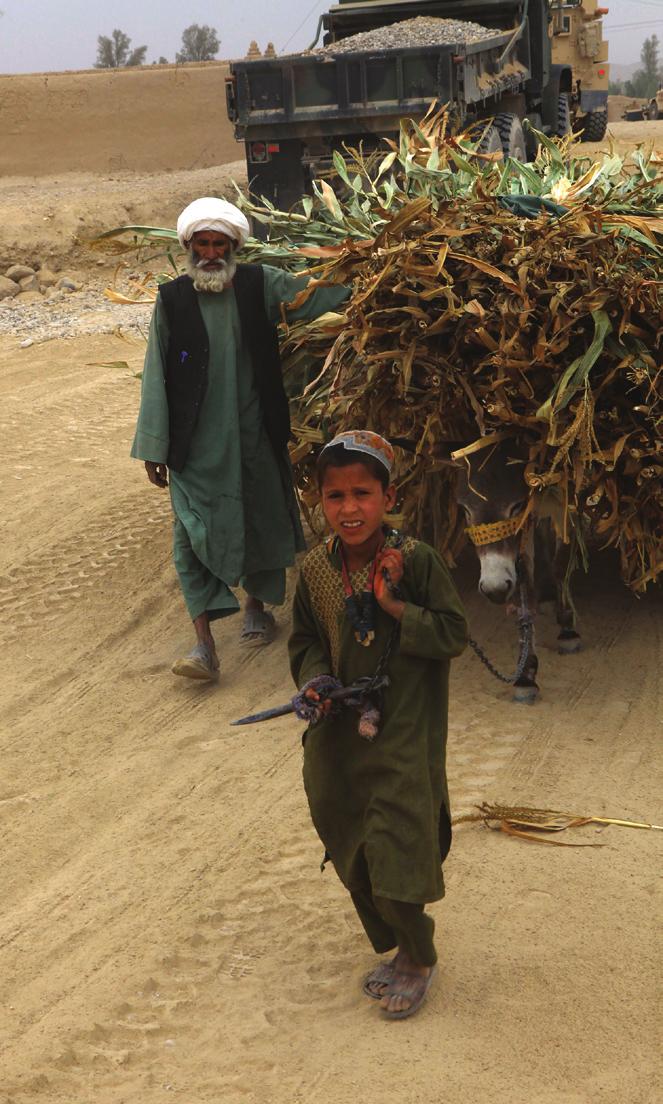 Page 5 IMPROVEMENT, continued from Page 4 Photo by (Above, Left) Afghan locals load and transport various crops in Helmand province, Afghanistan, Nov. 3.