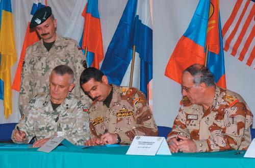 Othman, 8th Iraqi Army Division commander, sign documents transferring the security responsibilities of Diwaniya and Al Kut Provinces over to the 8th Iraqi Army Division Jan. 26 at Camp Echo.