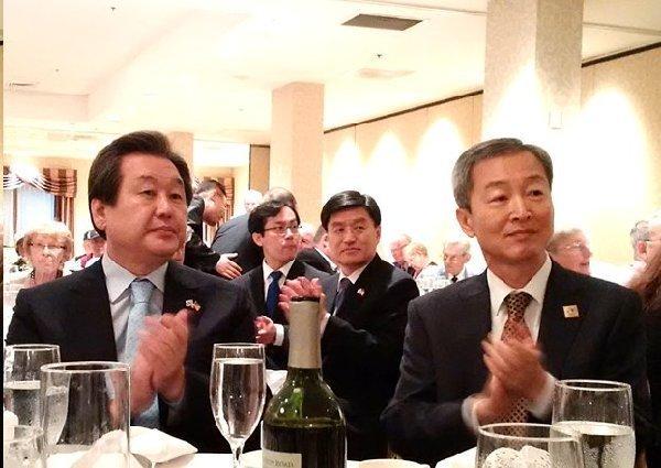 Page 12 of 14 Representative Kim Moo-sung (left) and His Excellency Ahn Ho-young, the Republic of Korea's Ambassador to the United States, applaud Korean War Veterans at a banquet sponsored by