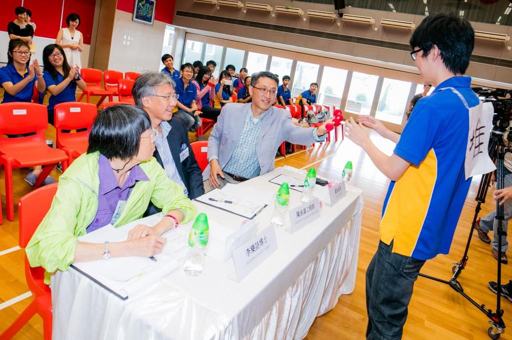 Photo Captions Photo 1: A student uses magic tricks to explain nuclear energy generation to the judges.