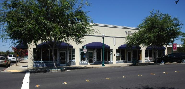 Another building, with four separate tenant spaces facing the street, created an upscale image by adding new window systems with tile accented areas, new cornice trim, and a series of rounded Navy
