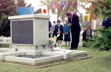 a man killed on Kwajalein, bows in prayer during a memorial
