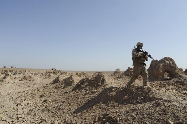 A Marine assigned to Special Operations Task Force-West in Herat province, Afghanistan, scans the area around him before moving forward during an Aug.