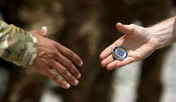 THE SECRET CHALLENGE COINS HAND SHAKE To watch a challenge coin being passed from one person to another is to witness the equivalent of the secret handshake.