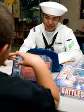 I think everyone in Sacramento is really excited to have another Navy Week in the future. Top: Airman Chaz Martin plays Battleship with a Student at Sacramento s 4th R program.
