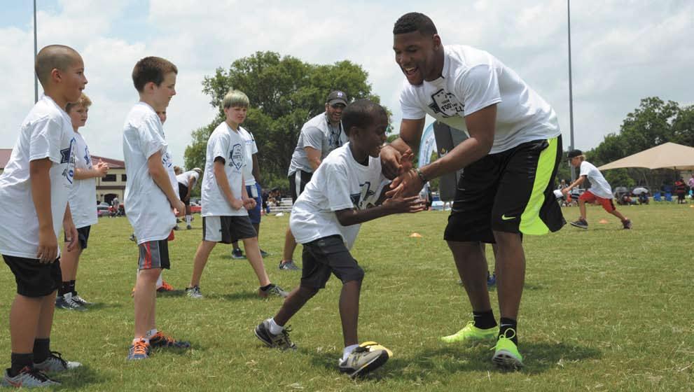 JULY 17, 2015 WINGSPREAD PAGE 11 Terrance Williams, Dallas Cowboy wide receiver, instructs children during a youth football camp July 7 at Joint Base San Antonio-Randolph.