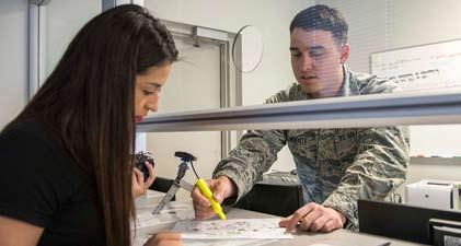 Kolton Glasoe, 502nd Security Forces Squadron entry controller, checks a visitor s ID card July 8 at the Joint Base San Antonio-Fort Sam Houston Visitor Control Center to receive a visitor pass and