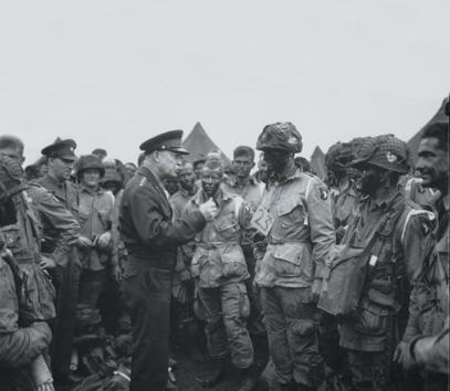 GEN Dwight D. Eisenhower talks with paratroopers before the D-Day invasion, 5 June 1944.