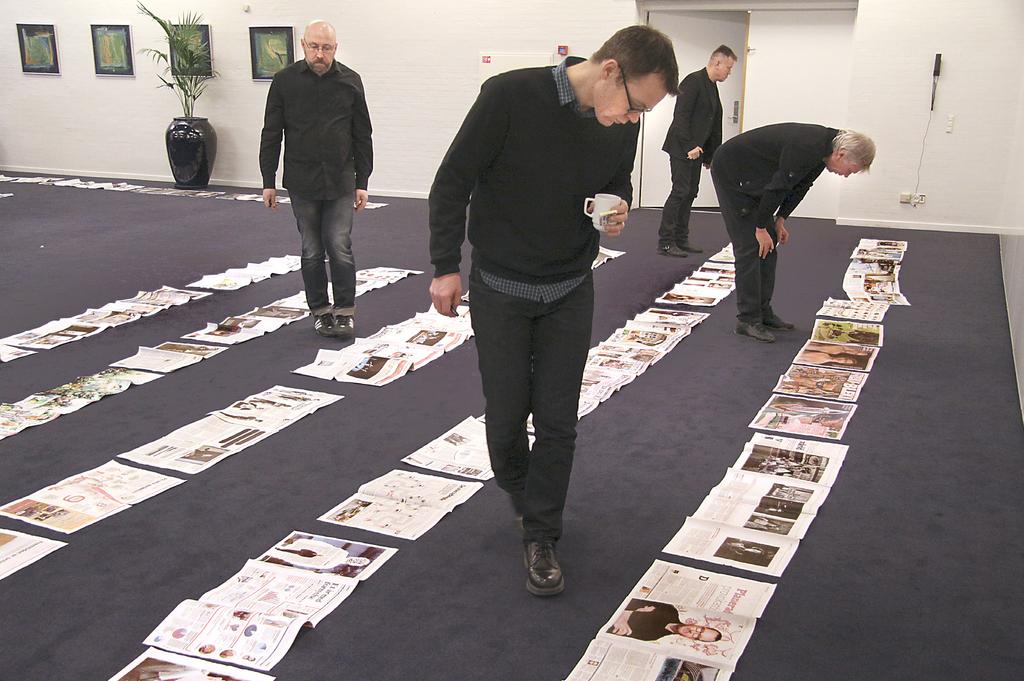DO WE HAVE A WINNER? Jury members in last year s competition look closely at some of the many entries the print categories. Photo: Lars Pryds.