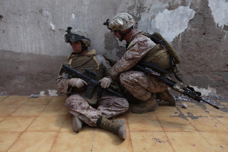 Sgt. Eric Schaufler, a squad leader with Company I, Battalion Landing Team 3/8, 26th Marine Expeditionary Unit, surveys the area near two mock casualties during a simulated vertical assault in