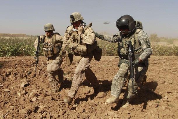 U.S. Marines carry stretchers as they run to pick up their wounded comrade during a Medevac mission in southern Afghanistan's Helmand Provinc e November 8, 2010. U.S. flight medic, SGT.