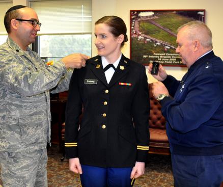 NEWEST CHAPLAIN Capt. Rachel Zarnke, center, is promoted to captain by Brig. Gen. Michael L. Cunniff, The Adjutant General, right and State Command Chaplain Lt. Col.