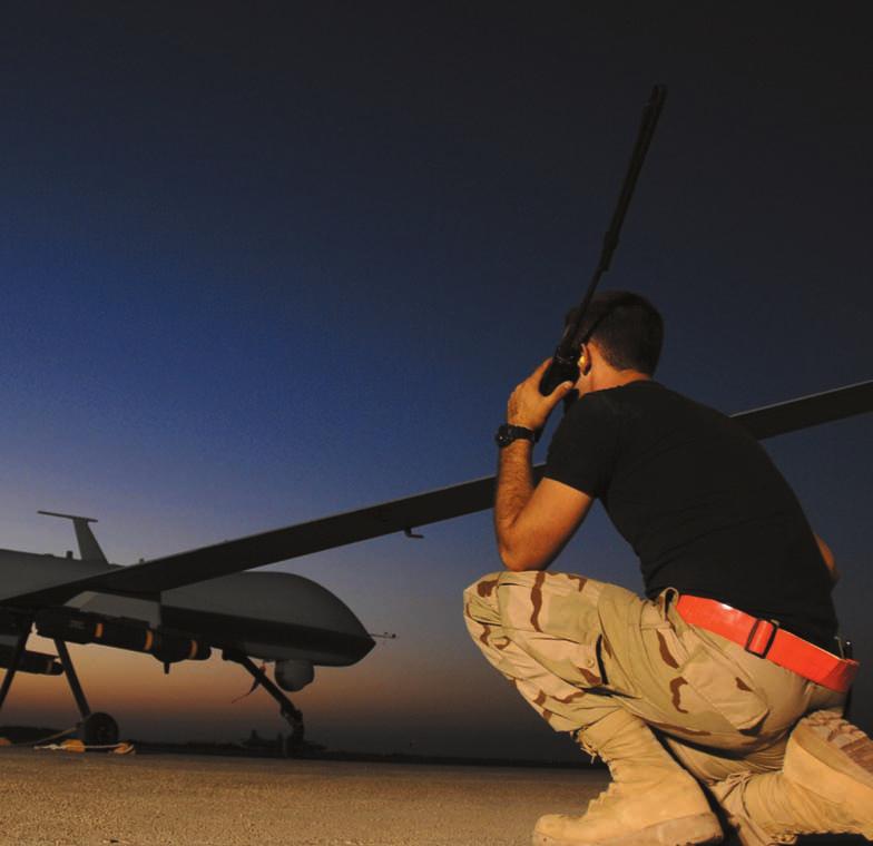 A1C Justin Cole speaks with the pilot of an MQ-1 Predator before a night mission from Ali AB, Iraq. An urgent need for intelligence prompted USAF to purchase RPAs at a rapid clip.