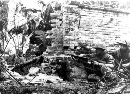 Center: Marines of Company A, 1st Battalion, 1st Marines, lower a wounded