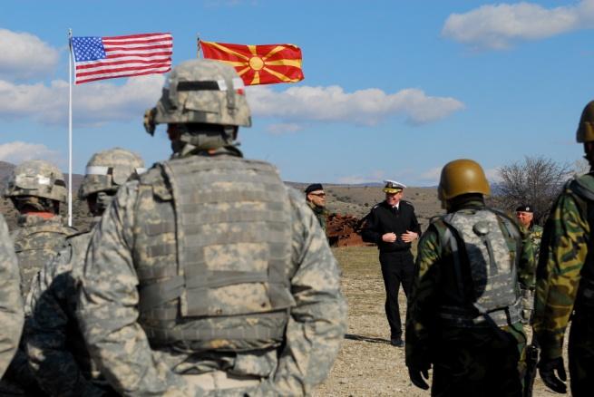 , native and a team leader with the 230th Military Police Company, 95th Military Police Battalion, while another Macedonian soldier takes aim during a crew-served weapons range at Army Training Area