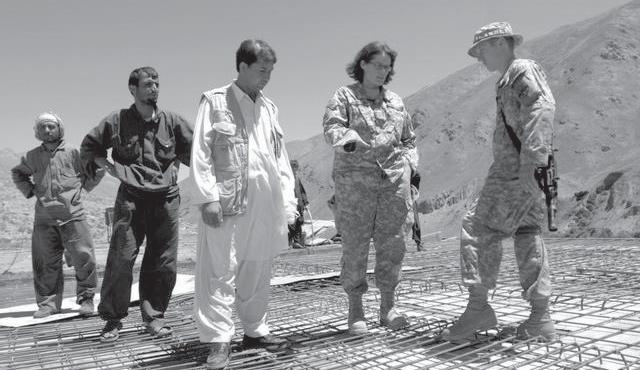 (U.S. Air Force, MSgt Jim Varhegyi) U.S. Air Force 1LT Lee Turcotte, right, a civil engineer, and Teresa Morales, civil engineer with the U.S. Army Corps of Engineers, discuss the progress of a school construction project with contractors in Panjshir Province, Afghanistan, 4 August 2007.
