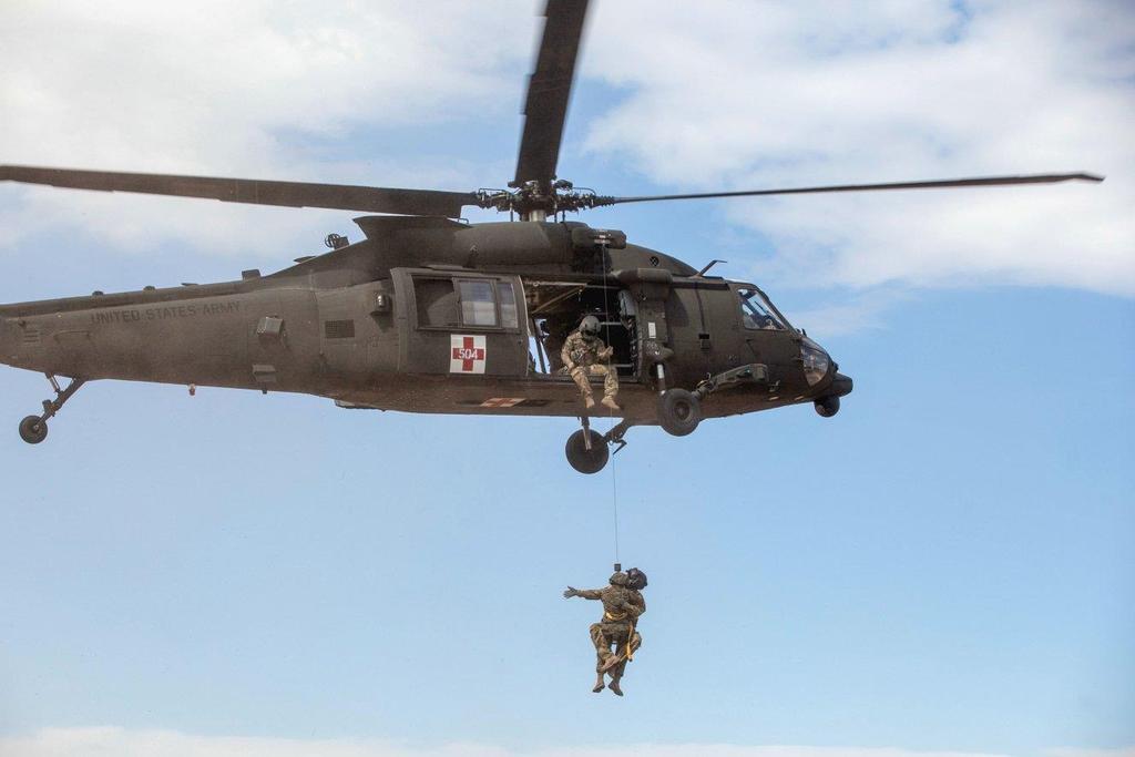Elements of Marine Forces Reserve Combat Logistics Battalion 25 conduct medical evacuation training with a US Army HH-60M helicopter from Charlie Company, 3-10 Aviation Battalion, at the Adazi range