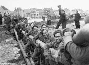 Canadians in Belgium 1944 Introduction ROYAL CANADIAN ENGINEERS LOWERING PIPE INTO ROADWAY EXCAVATION, OSTEND, OCTOBER 1944.
