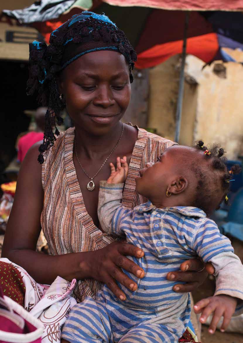 chapter two Children and Child Protection in the EVD Response A mother holds her baby daughter in a market in the city of Nzérékoré, Guinea. I.