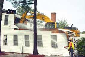 to qualify as a legitimately historic building. Many of those modifications were laid bare Monday morning as a bulldozer slowly toppled the structure.