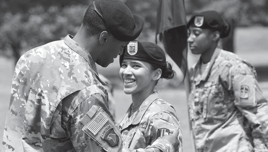 Photos by ROBERT TIMMONS Capt. Vanessa Ramirez, Fitness Training Company commander, smiles brightly as Lt. Col. Archie L.