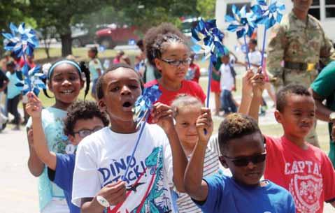 Above, Children s Trust of South Carolina handed out blue pinwheels to participants of the walk. The pinwheel is the national symbol for child abuse prevention.