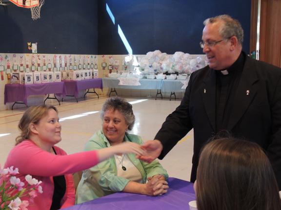 After mass, Archbishop Lori greeted the students and families. He is scheduled to celebrate St. Elizabeth Ann s birthday celebration and mass at the Basilica on August 31 at 1:30 p.m. VINCENTIAN SUPERIOR GENERAL VISITS MSS 6th grade student, Darren Byrne, presents the gifts to Archbishop William E.