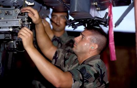 Kirk McManious works on fitting an AIM- 120 missile to an F-15 launchrail. Tyndall is also a training ground for F-15 crew chiefs.
