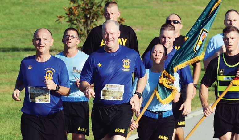 Photos by ROBERT TIMMONS Brig. Gen. John Pete Johnson, Fort Jackson commander, leads the post staff and a formation of Soldiers during the Sixth Annual Run for the Fallen Aug. 13 at Hilton Field.