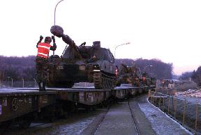 Terminal Planning Considerations M109A3 Howitzers are loaded onto flatcars for movement to a forward assembly area.