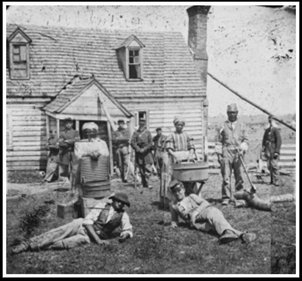 This is a photograph of a group of contrabands at Allen's farm house near Williamsburg Road in Yorktown, Virginia (vicinity).