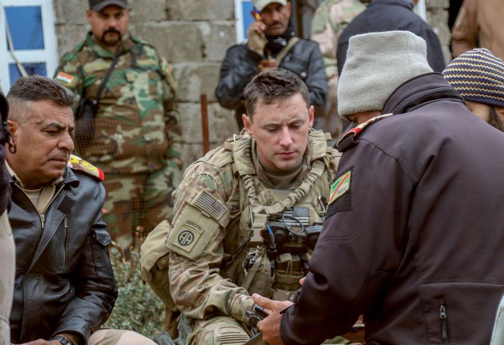U.S. Soldier deployed in support of CJTF Operation Inherent Resolve discusses operations with 9 th Iraqi army division leaders during offensive to liberate West Mosul from Islamic State, near Al