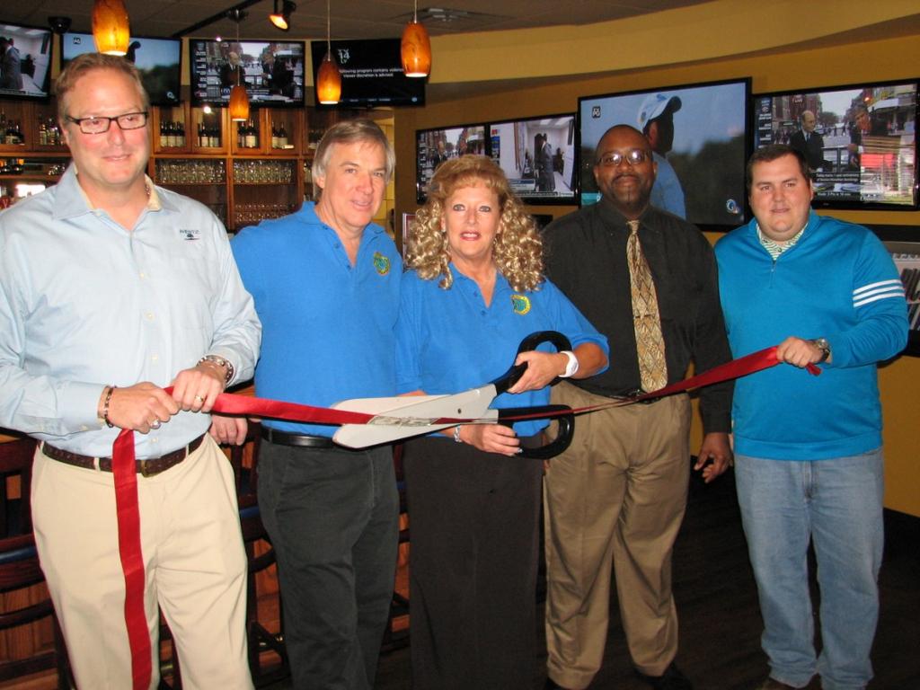 On April 15, Marc and Kathy Leavell, owners of Ground Round Grill & Bar, along with their manager Darnell Harris, are shown at their Ribbon Cutting Ceremony.