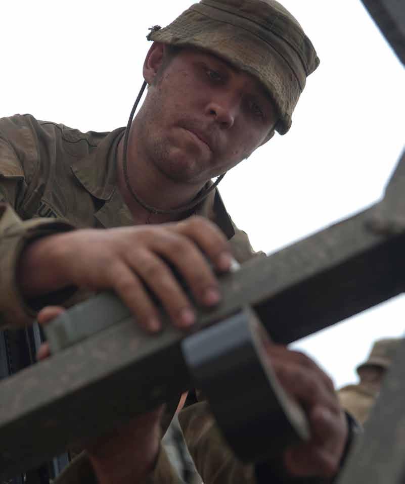 A sapper from Australia s 1st Combat Engineers Regiment, 1st Field Squadron, 2nd Troop plants a block of explosives to cut through a metal structure during Talisman Sabre 2011.