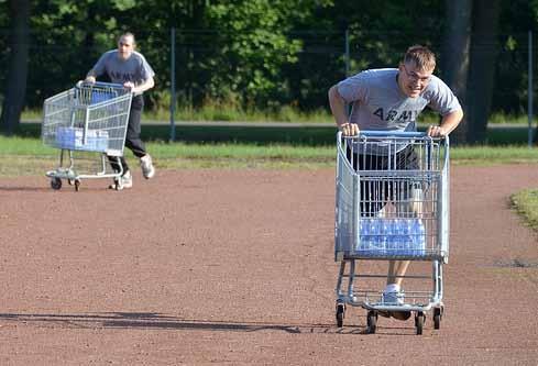 left SGT Toby Hensley does his lap during the Shopping Cart Relay.