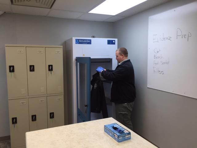 Evidence Prep Shown above is Evidence Tech, Trevor Radtke, who is processing an item of clothing in the new Safe-Dry drying unit.
